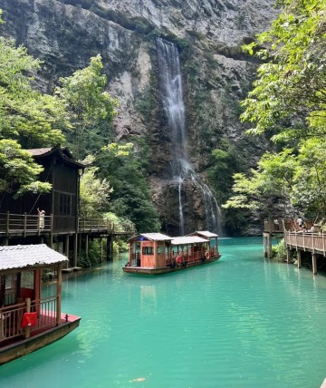 The boat is in the clear blue lake.