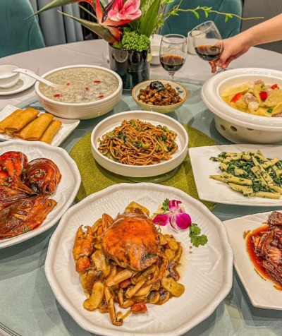 The table is filled with a variety of Chinese dishes.