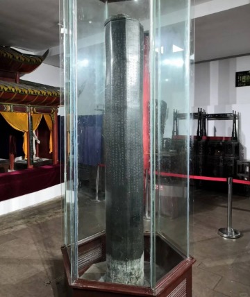 A centuries-old ancient Chinese bronze pillar, engraved with countless inscriptions.