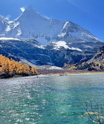 The river in Daocheng Yading is a bright blue, crystal clear.