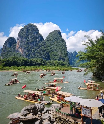 There are many cruise boats at the dock on the Li River.