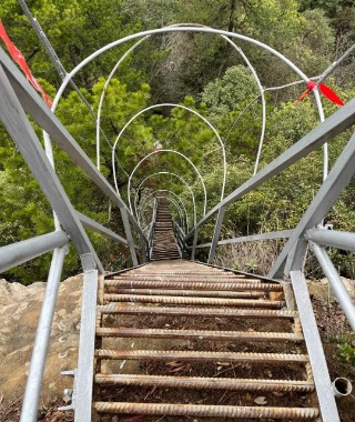 An iron staircase almost at a 180° angle.