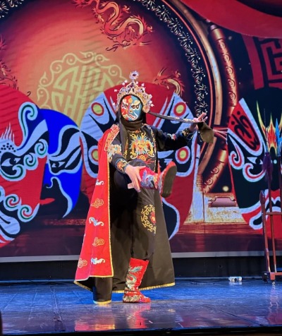 The performers on stage are doing the Sichuan opera face-changing.