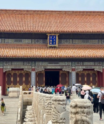 Tourists are lining up to enter a building inside the Forbidden City.