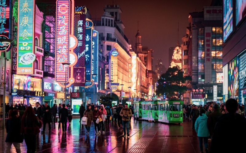 At night, colorful lights brighten up everywhere in China, and people are out shopping.