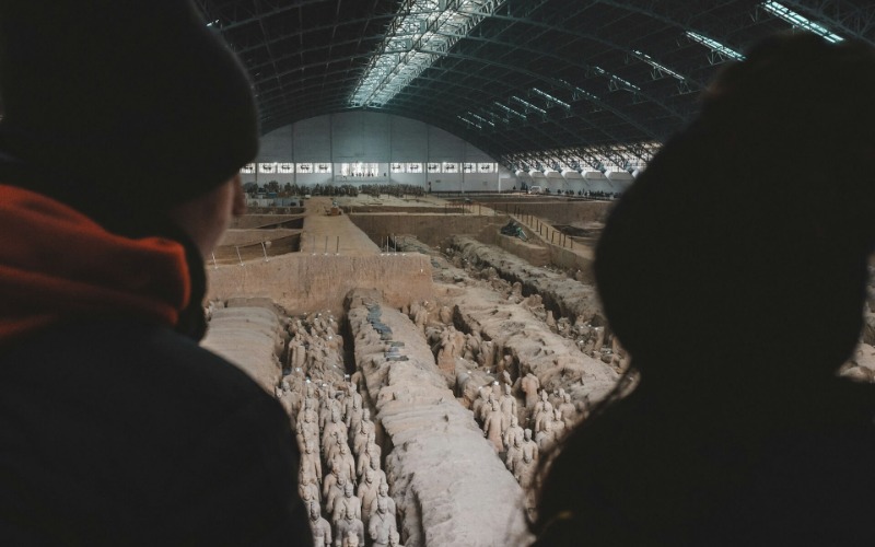 The tourists are visiting the Terracotta Army of Emperor Qin Shi Huang.