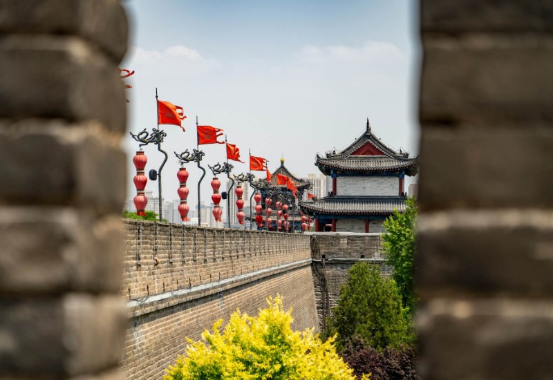 The wall is lined with red flags.